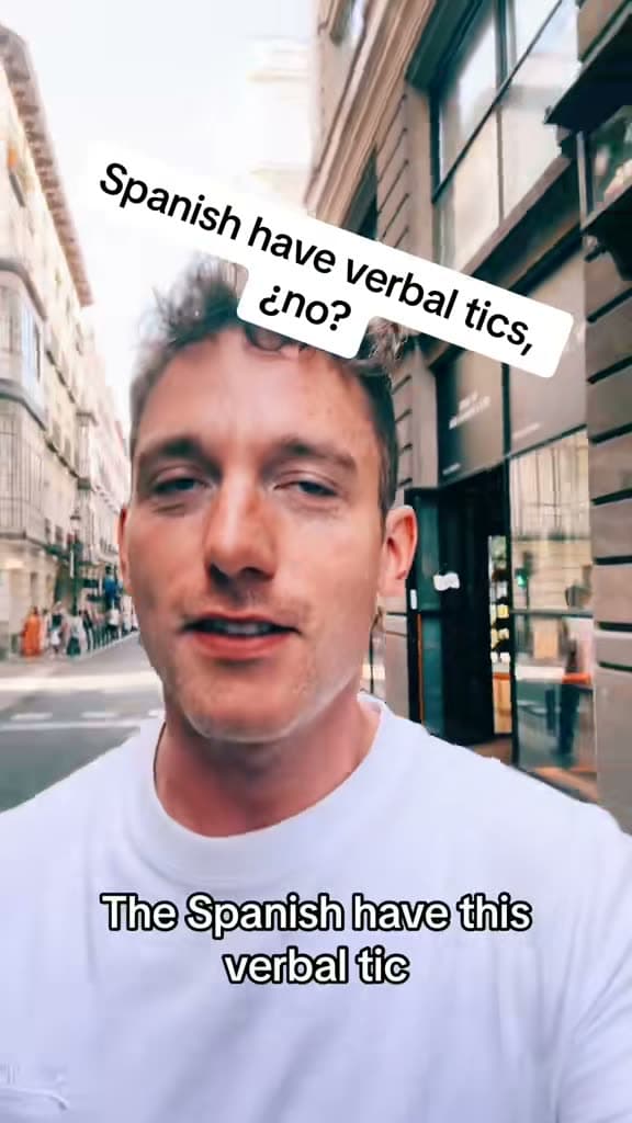 Christopher Adams on a street in Spain; the title card reads Spanish have verbal tics, no?