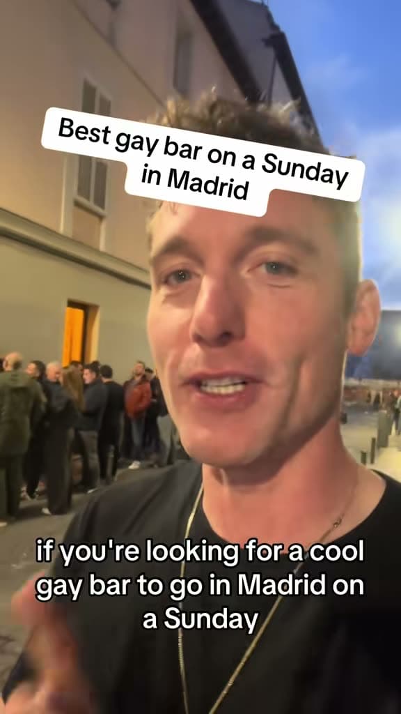 Christopher Adams outside a bar at dusk; the title card reads Best gay bar on a Sunday in Madrid