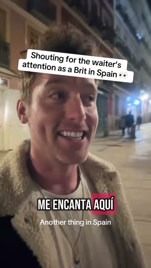 Christopher Adams on a street at night; the title card reads Shouting for the waiter's attention as a Brit in Spain