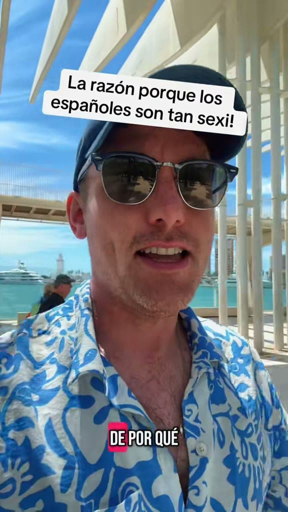 Christopher Adams in sunglasses and a patterned shirt on a sunny waterfront; the title card reads La razón porque los españoles son tan sexi