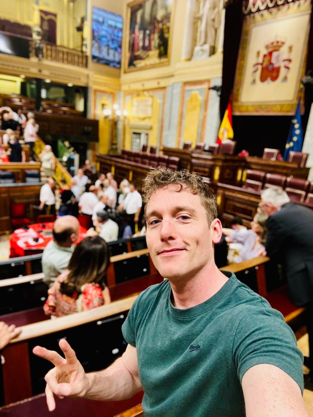 Christopher Adams giving a peace sign in the chamber of Spain's Congress of Deputies